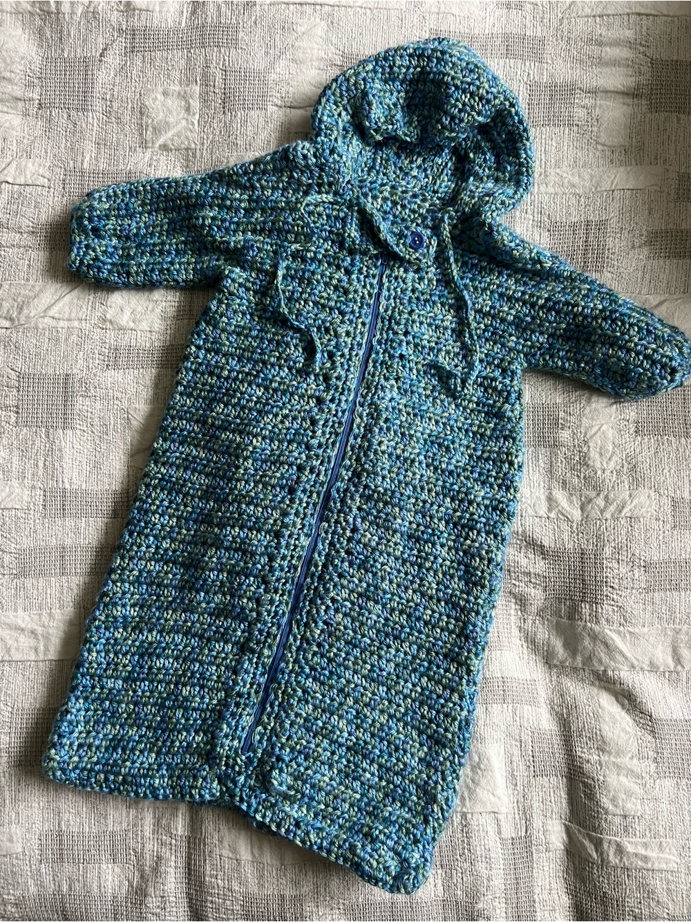Beautiful handmade crocheted hooded baby suit in gorgeous shades of blue